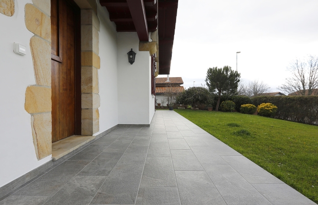 Renovation of exterior stone terrace with tile installation in Hendaye